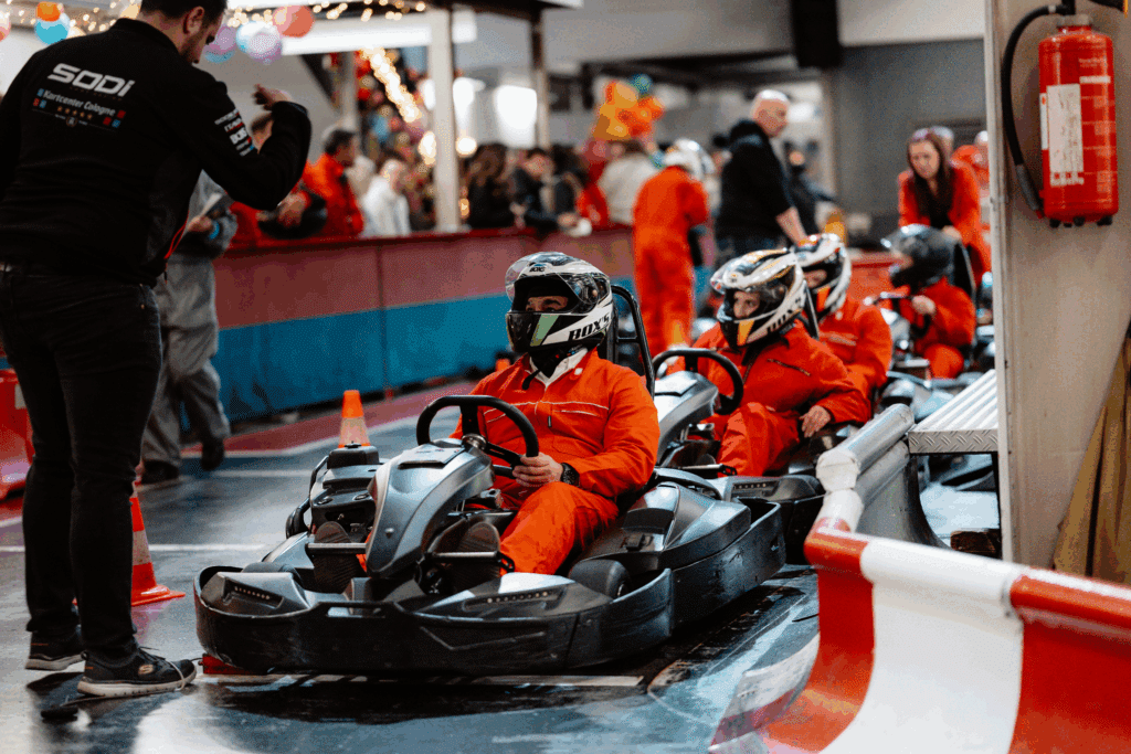Karts in Startaufstellung im Kartcenter Cologne, Zuschauer beobachten gespannt das Kartfahren Köln.