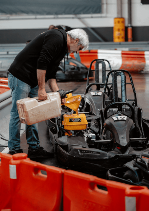 Mitarbeiter des Kartcenter Cologne betanken Karts für das Kartfahren Köln mit Benzinkanistern.